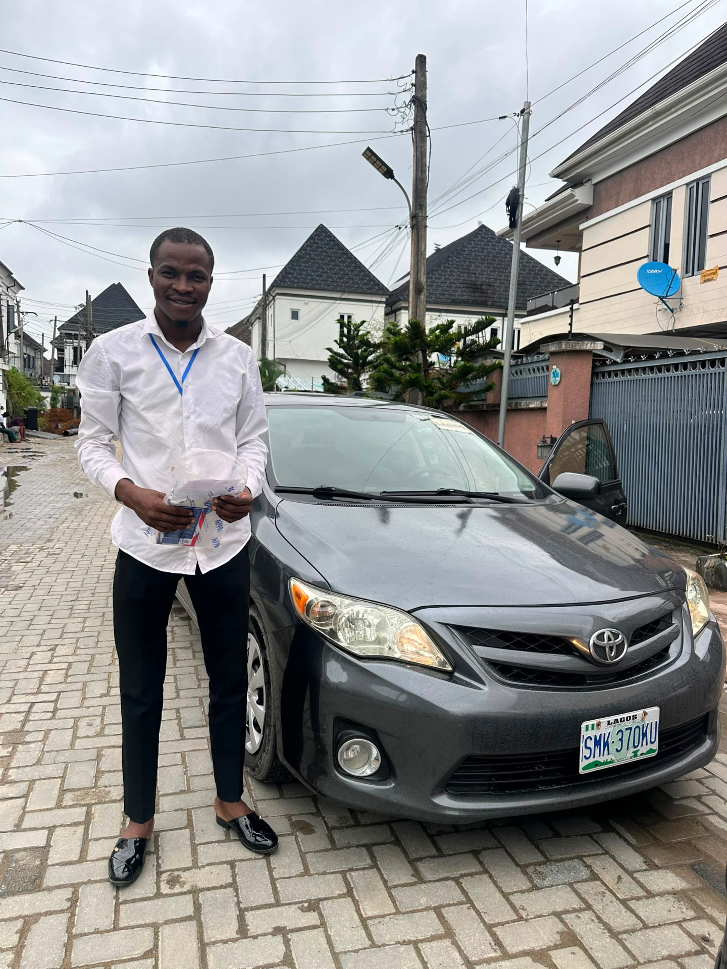 Green Autos customer standing beside his Toyota after delivery